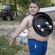 Illustration for article titled Is This Boy Magnetic? No, Just a Cute Fat Kid with Sticky Skin
